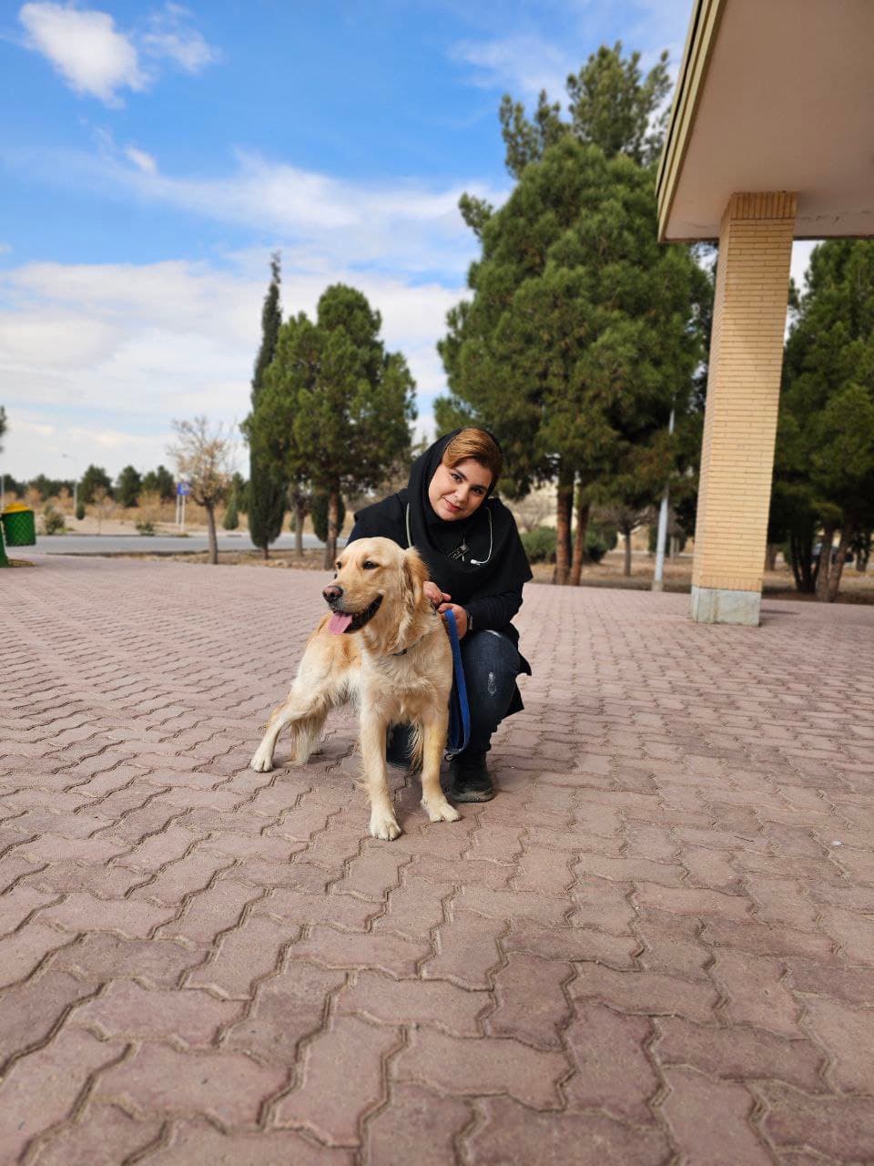 Dr. Ahmadi with a dog.